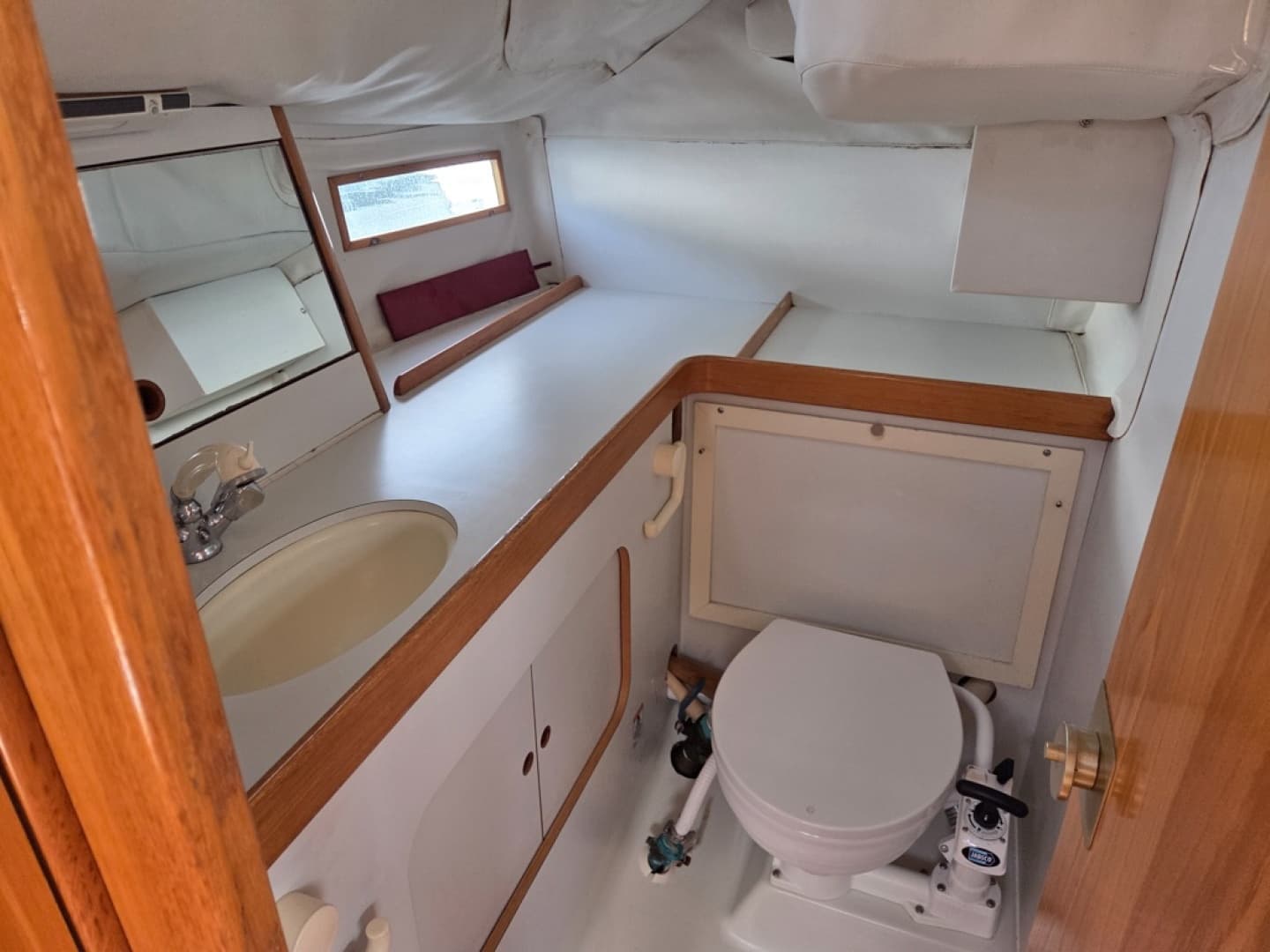 Interior of 1988 Beneteau Oceanis 350 head with sink, toilet, and shower head
