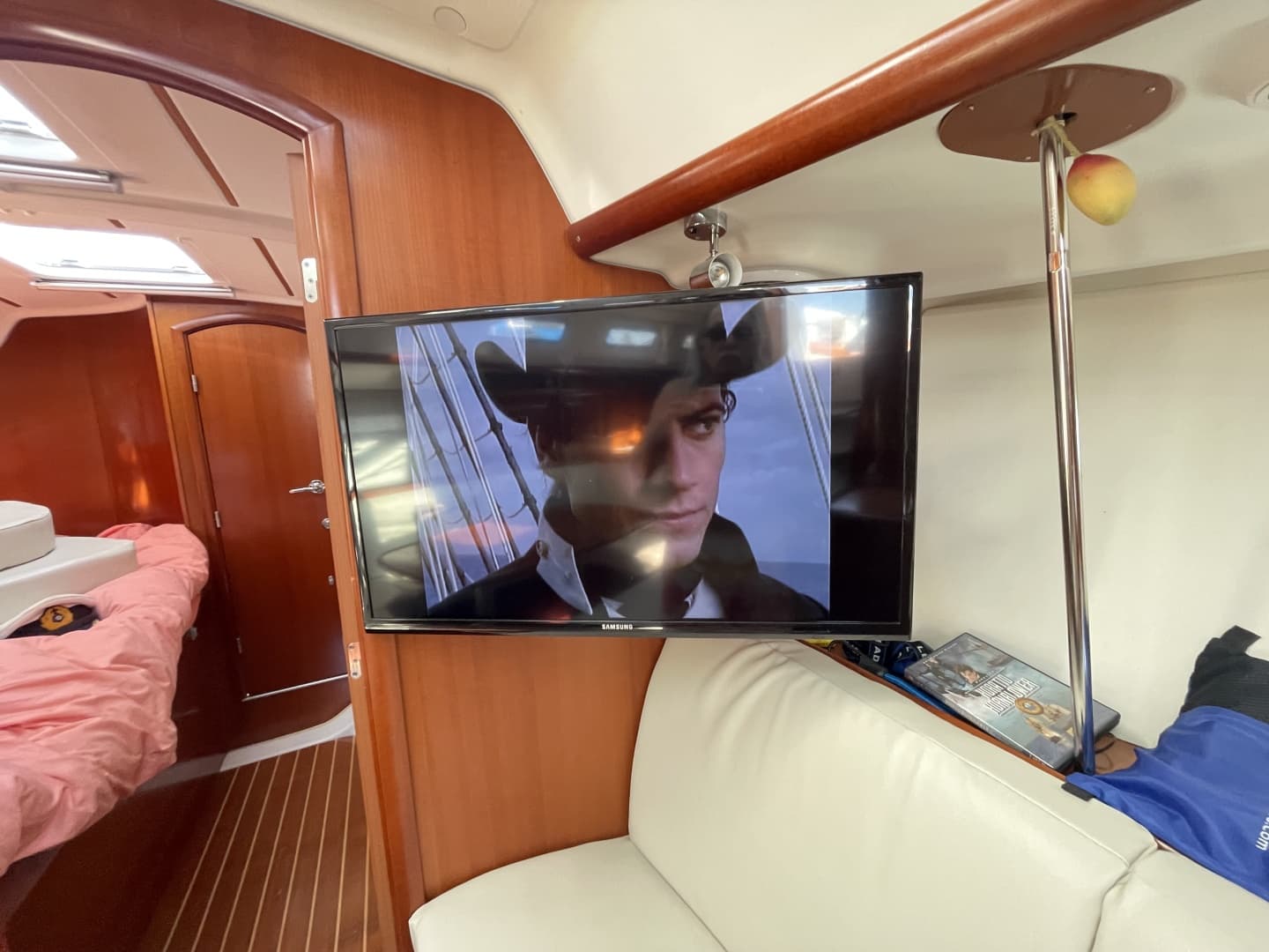 Interior of 2007 Beneteau 393 yacht with TV and cozy seating area