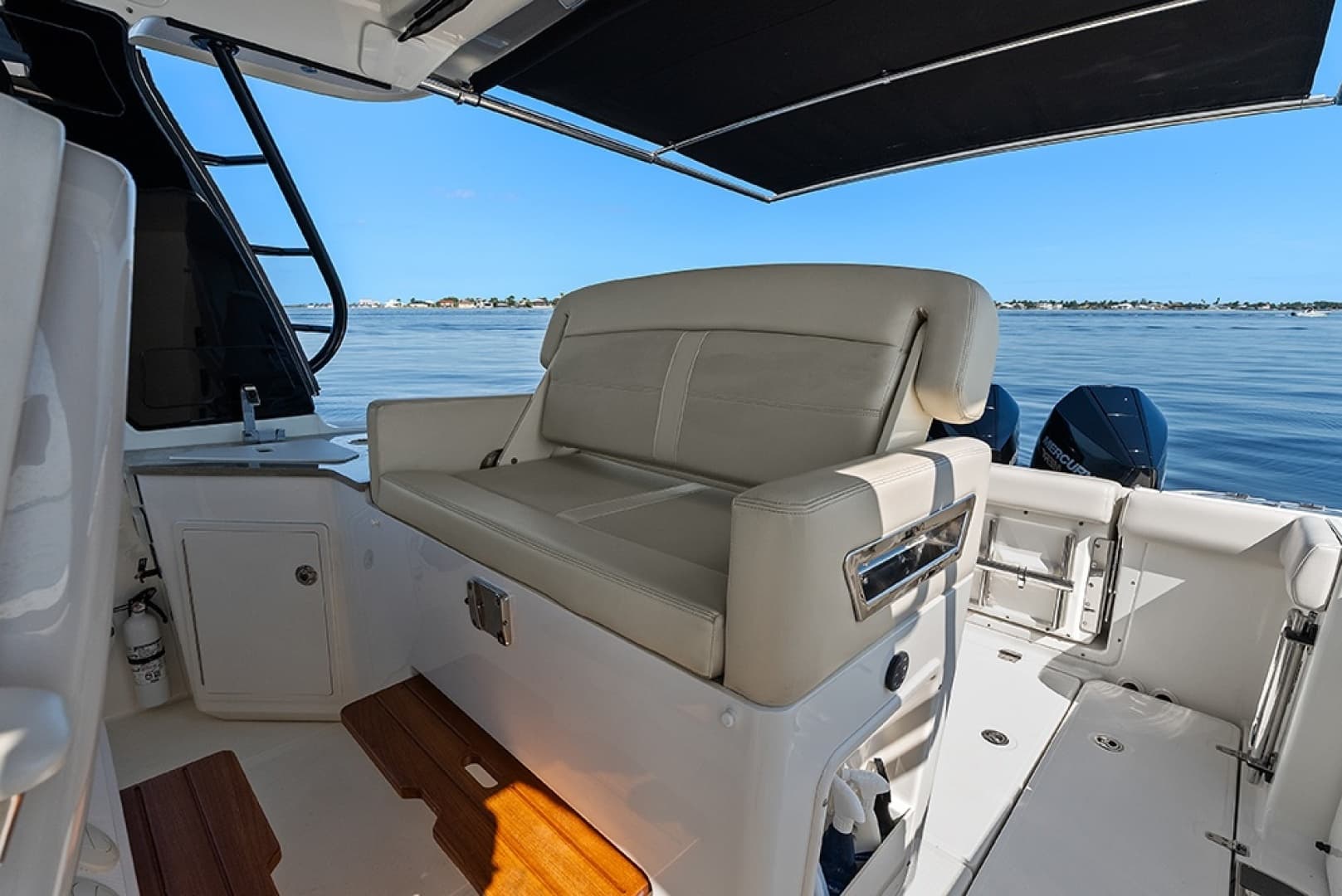 Helm deck second row seat with a conversation seatback