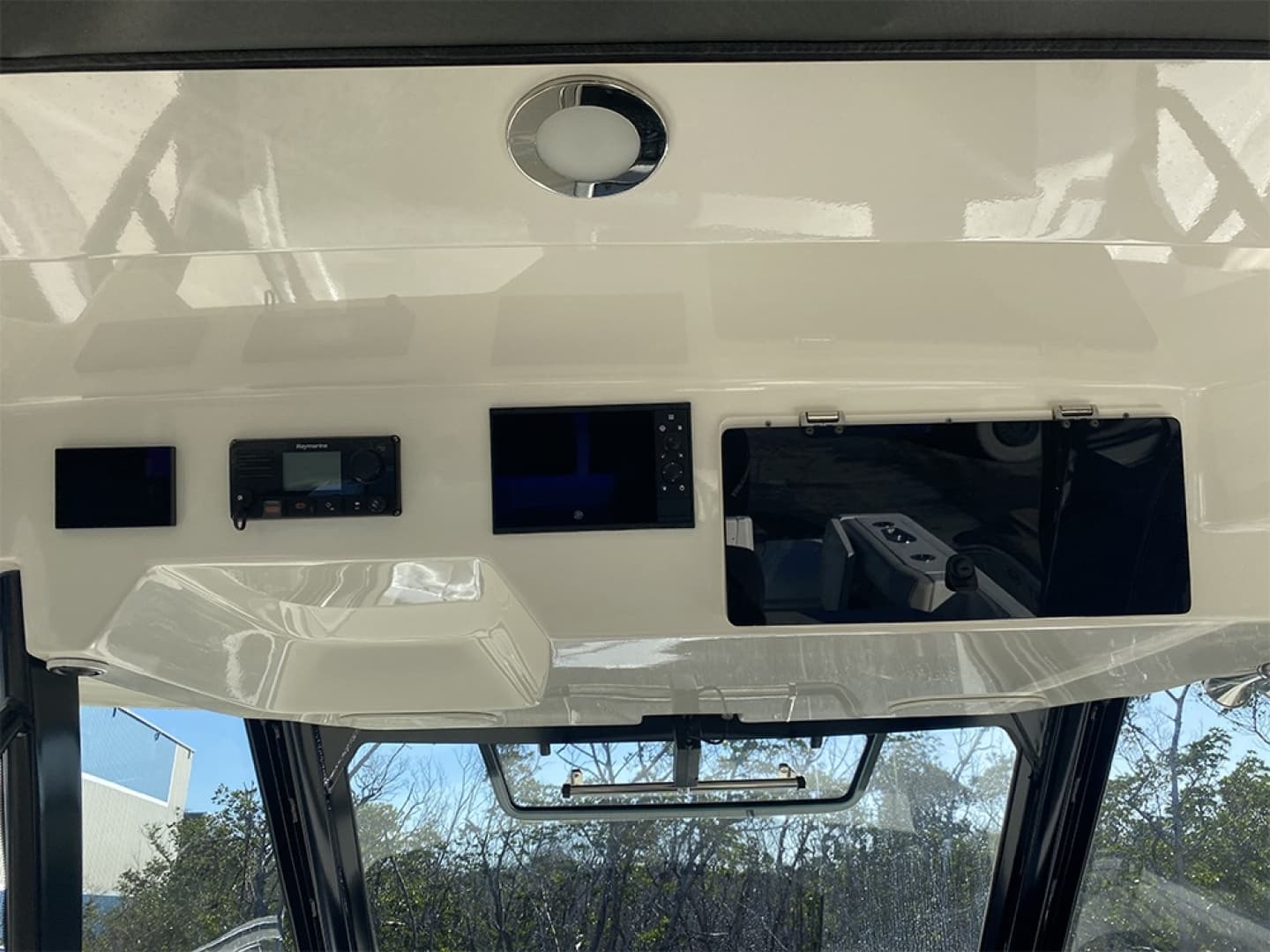2023 Boston Whaler 350 Realm dashboard with electronic controls and storage compartments.