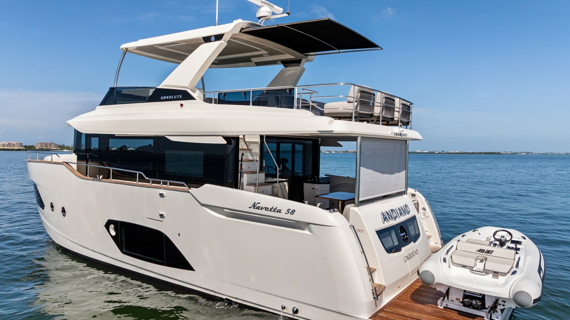 2026 Absolute Navetta 58 "ANDIAMO" Showcases a Sleek Design with a Convenient Tender Storage Platform. The Spacious Area Includes a Teak-Finished Deck, Providing an Elegant Touch and Easy Access to the Water.