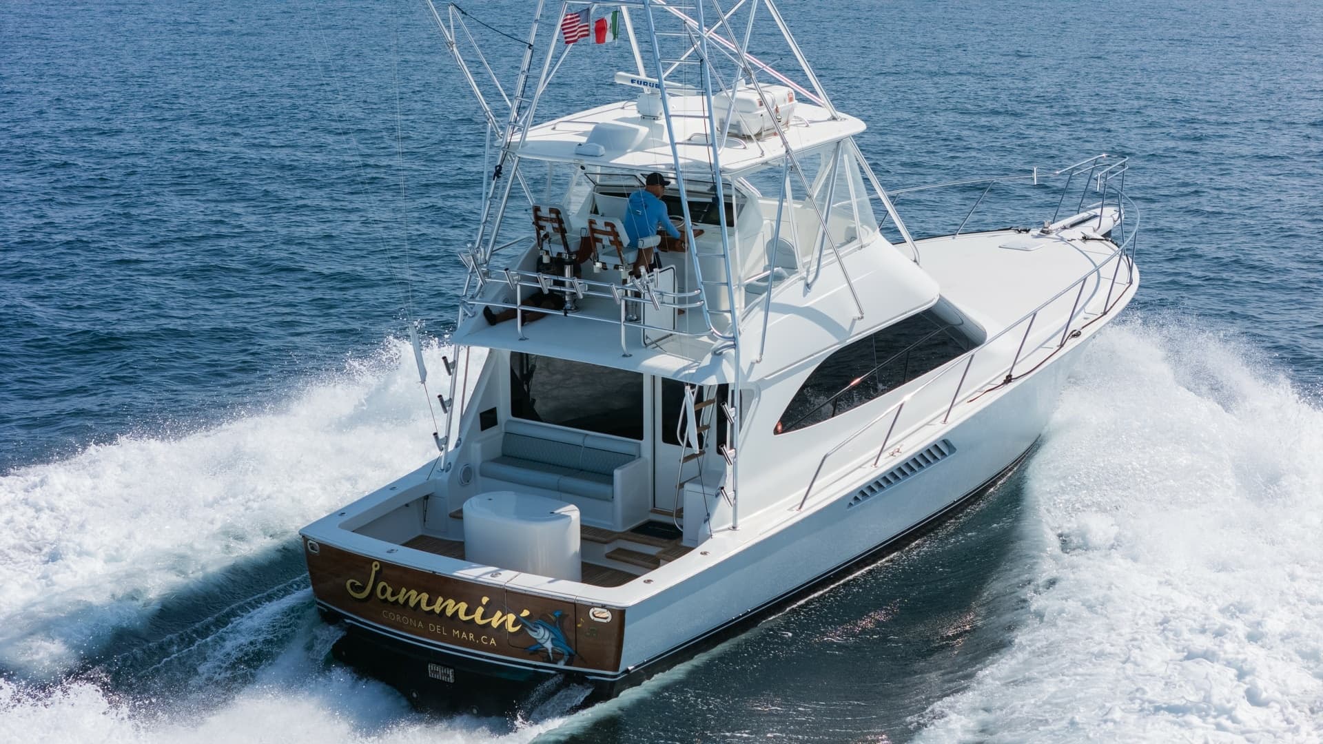 2009 Viking 50 Convertible "Jammin" - Aft-starboard view highlighting the yacht's graceful profile and on-water presence.