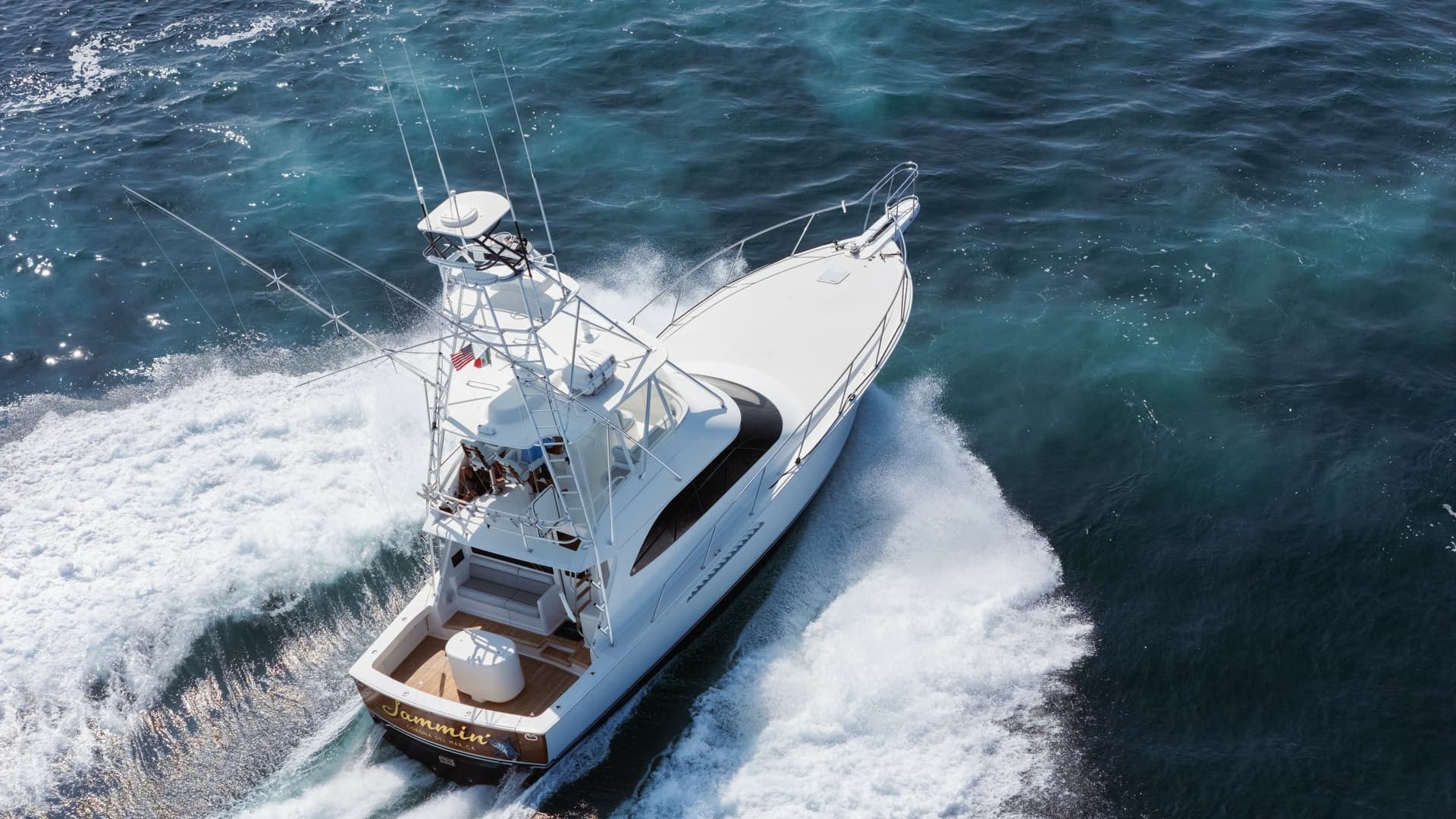 2009 Viking 50 Convertible "Jammin" - Aft-starboard view highlighting the yacht's graceful profile and on-water presence.